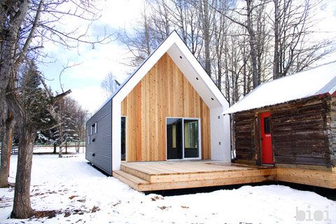 modern juxtaposed with old rustic log cabin